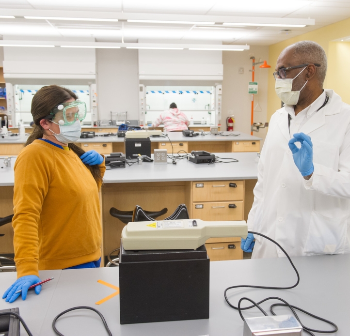 Student with professor in chemistry lab