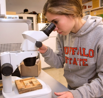 Biology student at a microscope