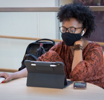 Student wearing mask using laptop