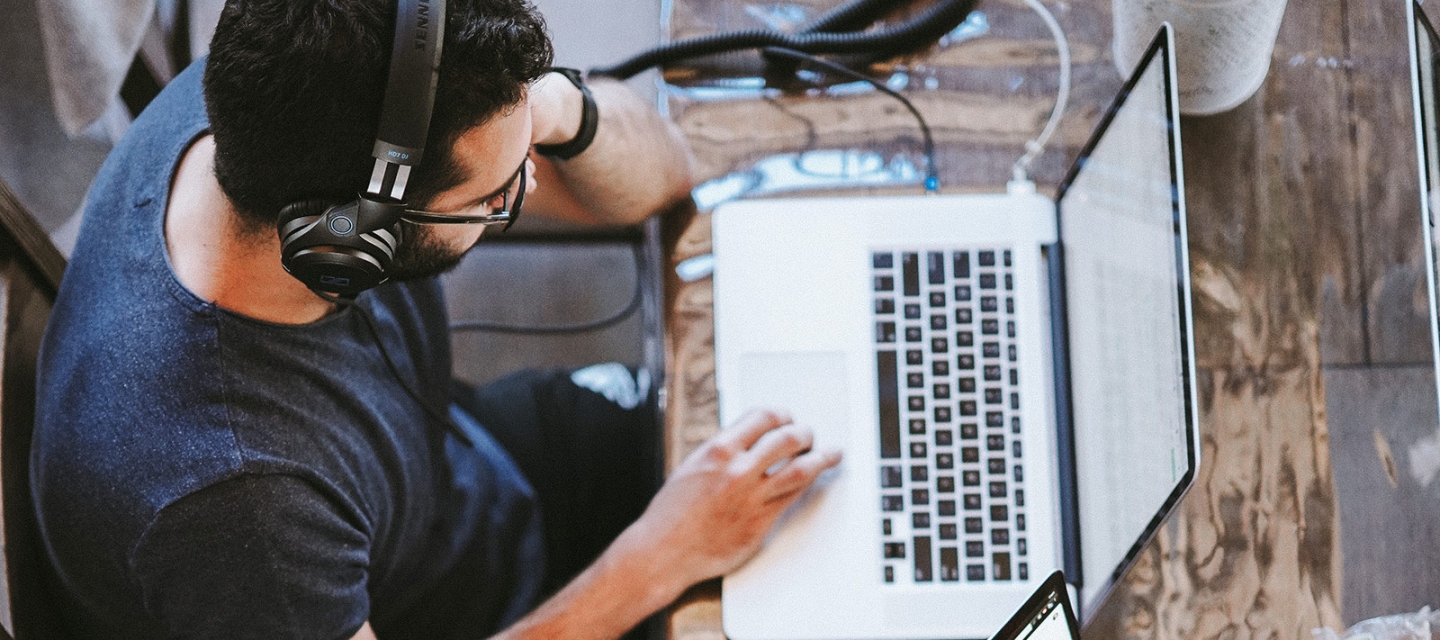 Students with laptops at a table