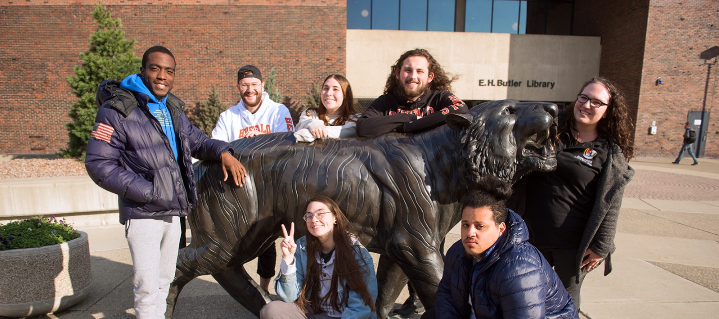 Students grouped around the bengal statue