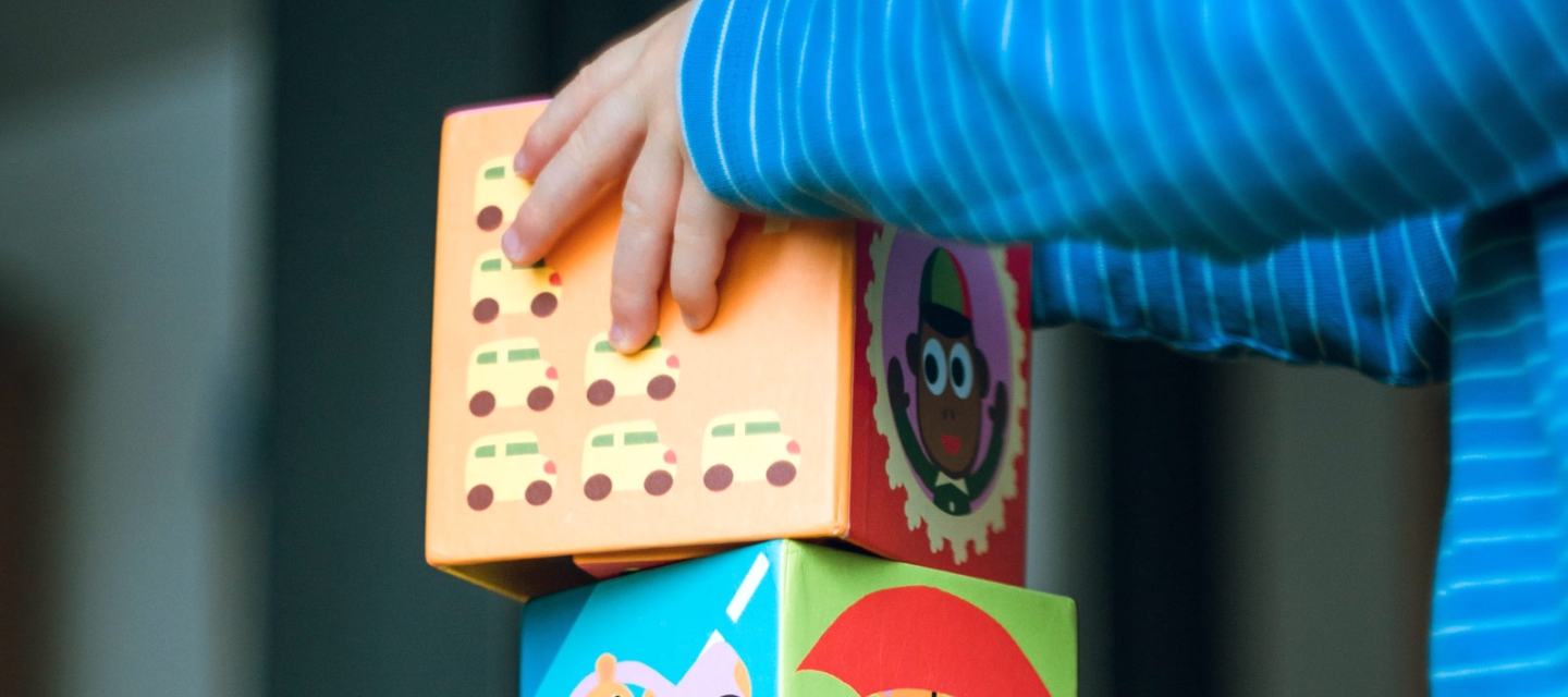 Young child stacking blocks